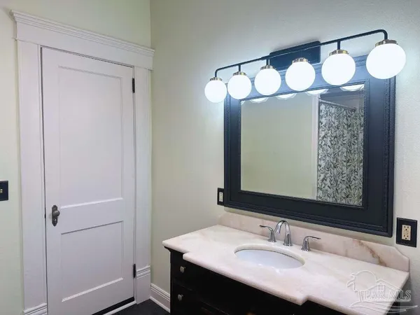a bathroom with a sink vanity and a mirror