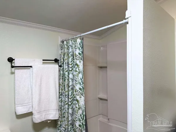 a bathroom with a shower and a glass door
