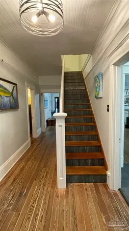 a view of entryway and hall with wooden floor