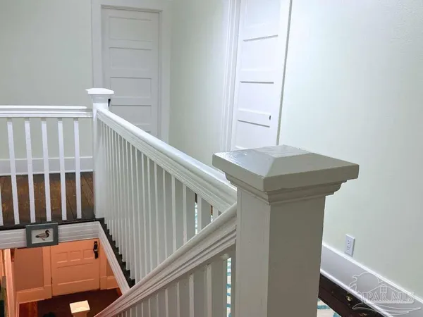 a view of a hallway with staircase