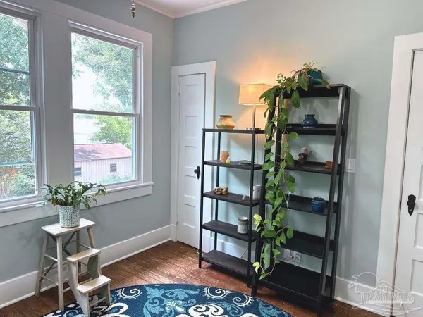 a workspace room with furniture and a potted plant