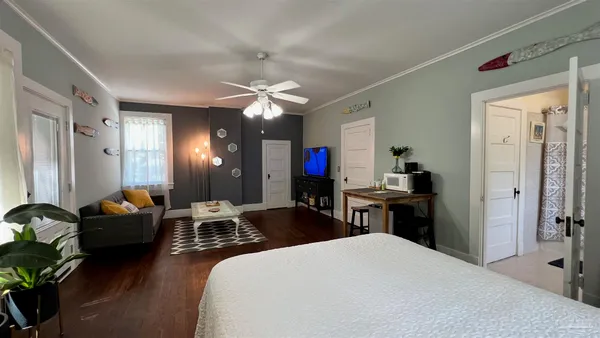 a bedroom with a bed and a chandelier