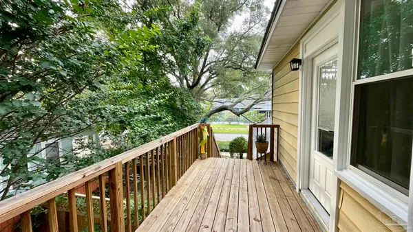 a view of balcony with chairs and wooden floor