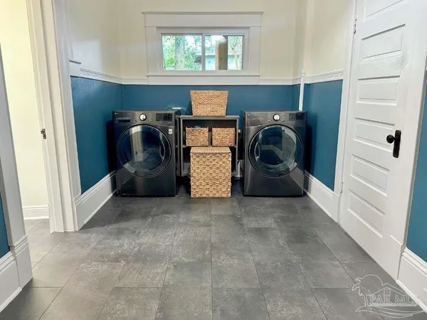 a utility room with closet dryer and washer
