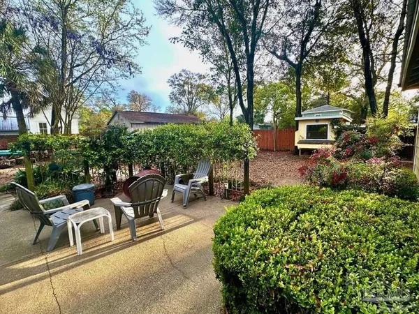 a backyard of a house with table and chairs