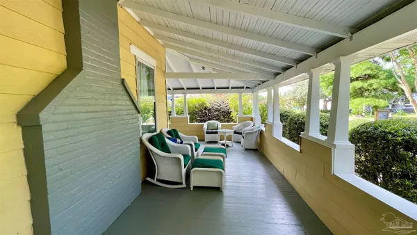 a balcony with furniture and a potted plant