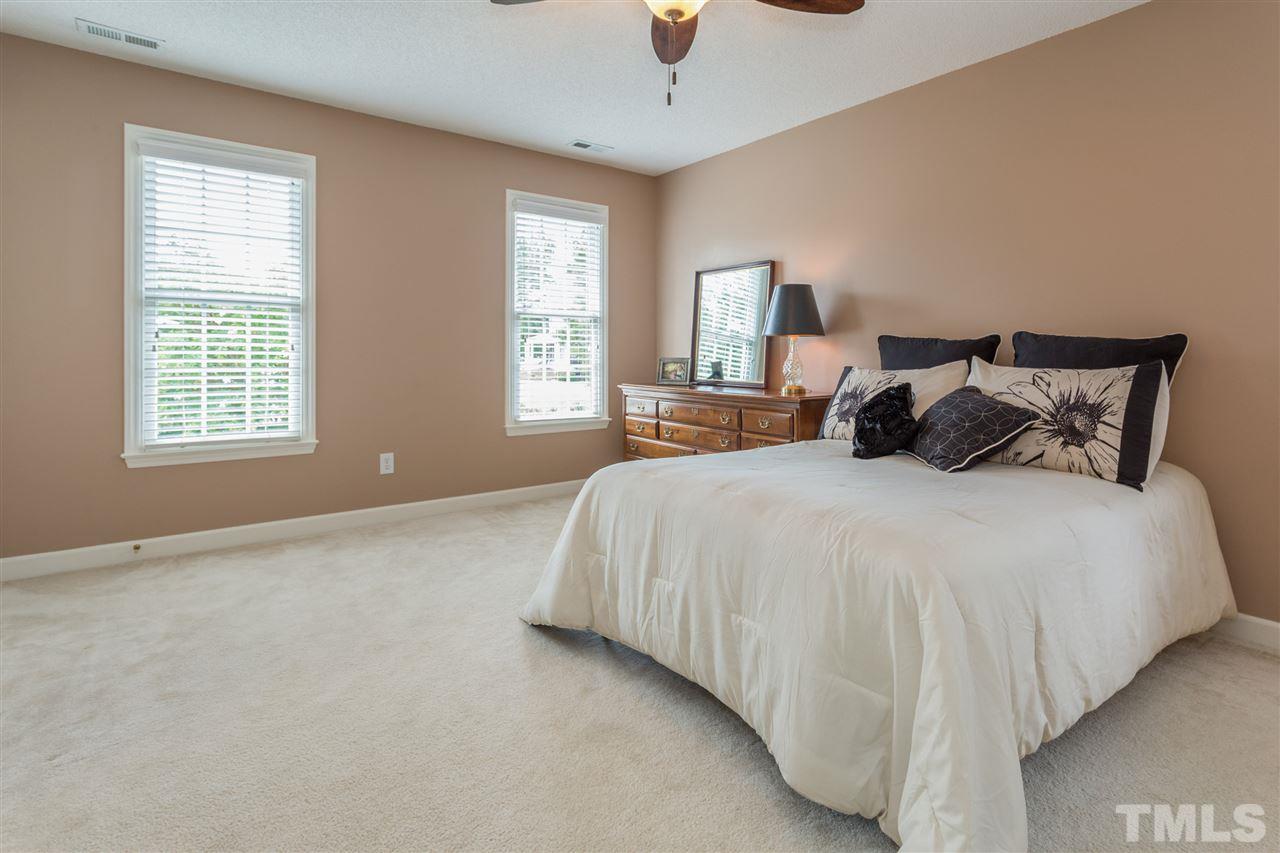 3225 Sandy Bluff Road Raleigh, NC 27616 - Photo 17 of 25 a bedroom with a bed and a chandelier