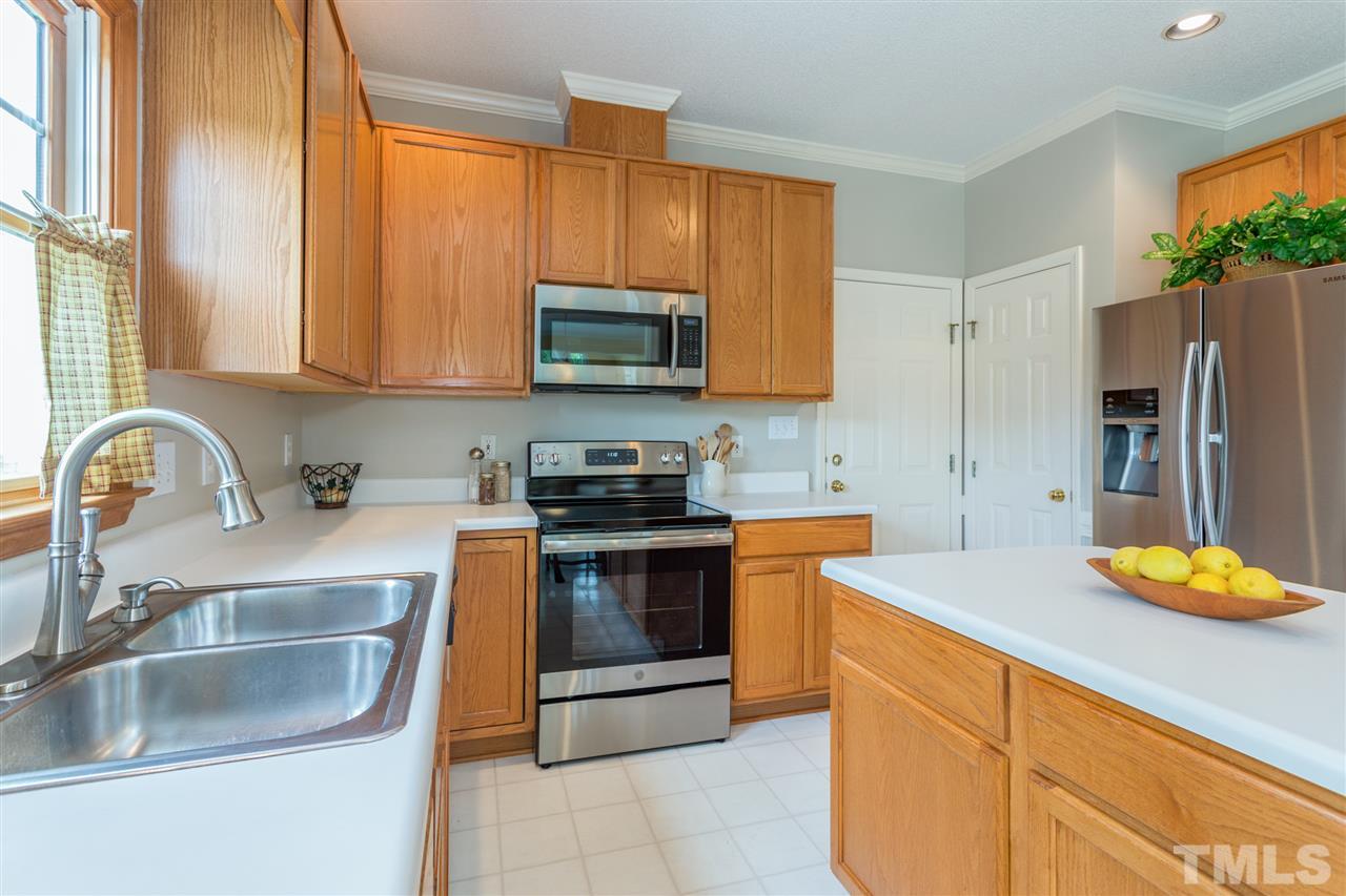 3225 Sandy Bluff Road Raleigh, NC 27616 - Photo 6 of 25 a kitchen with stainless steel appliances granite countertop a sink stove and refrigerator
