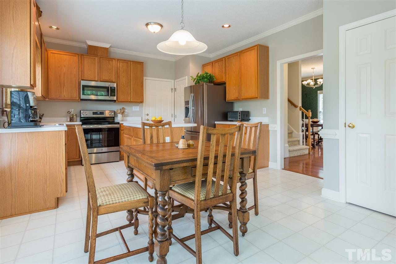 3225 Sandy Bluff Road Raleigh, NC 27616 - Photo 9 of 25 a view of a dining room with furniture and a kitchen