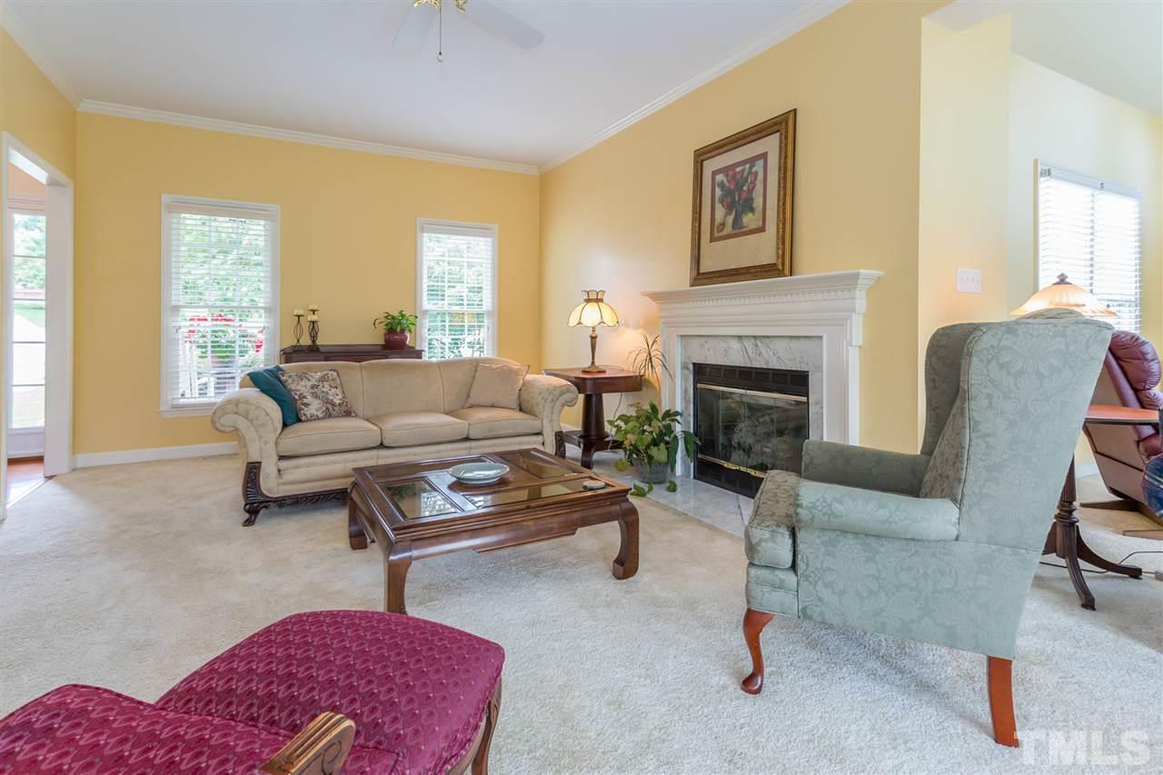 3225 Sandy Bluff Road Raleigh, NC 27616 - Photo 10 of 25 a living room with furniture and a fireplace