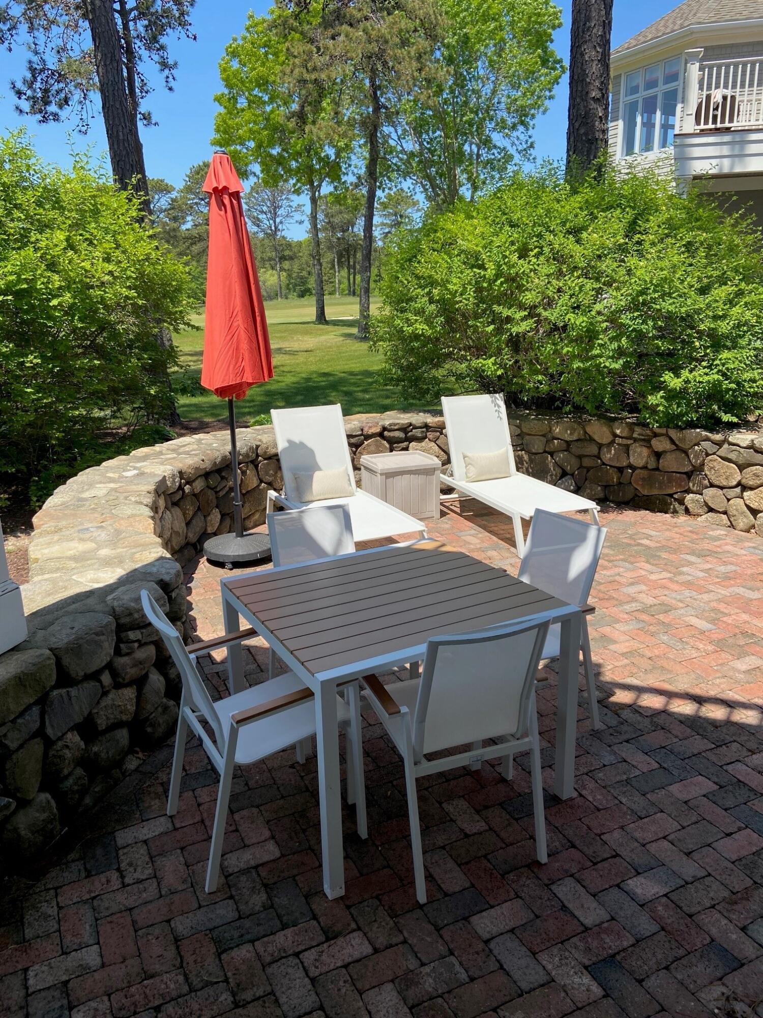 74 Simons Road, Unit B Mashpee, MA 02649 - Photo 6 of 11 a view of a backyard with furniture and a yard