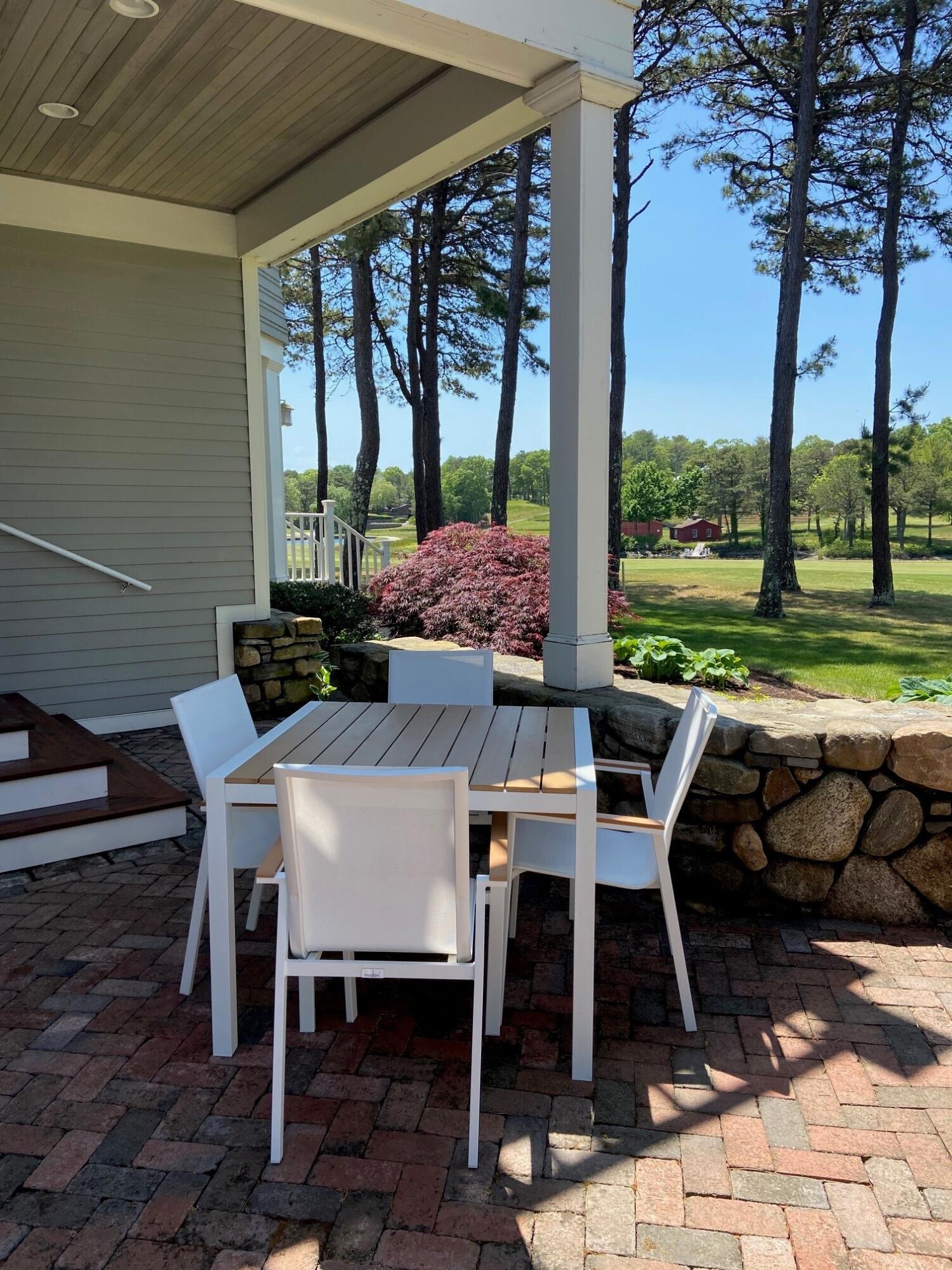 74 Simons Road, Unit B Mashpee, MA 02649 - Photo 7 of 11 a outdoor dining space with furniture and outdoor view