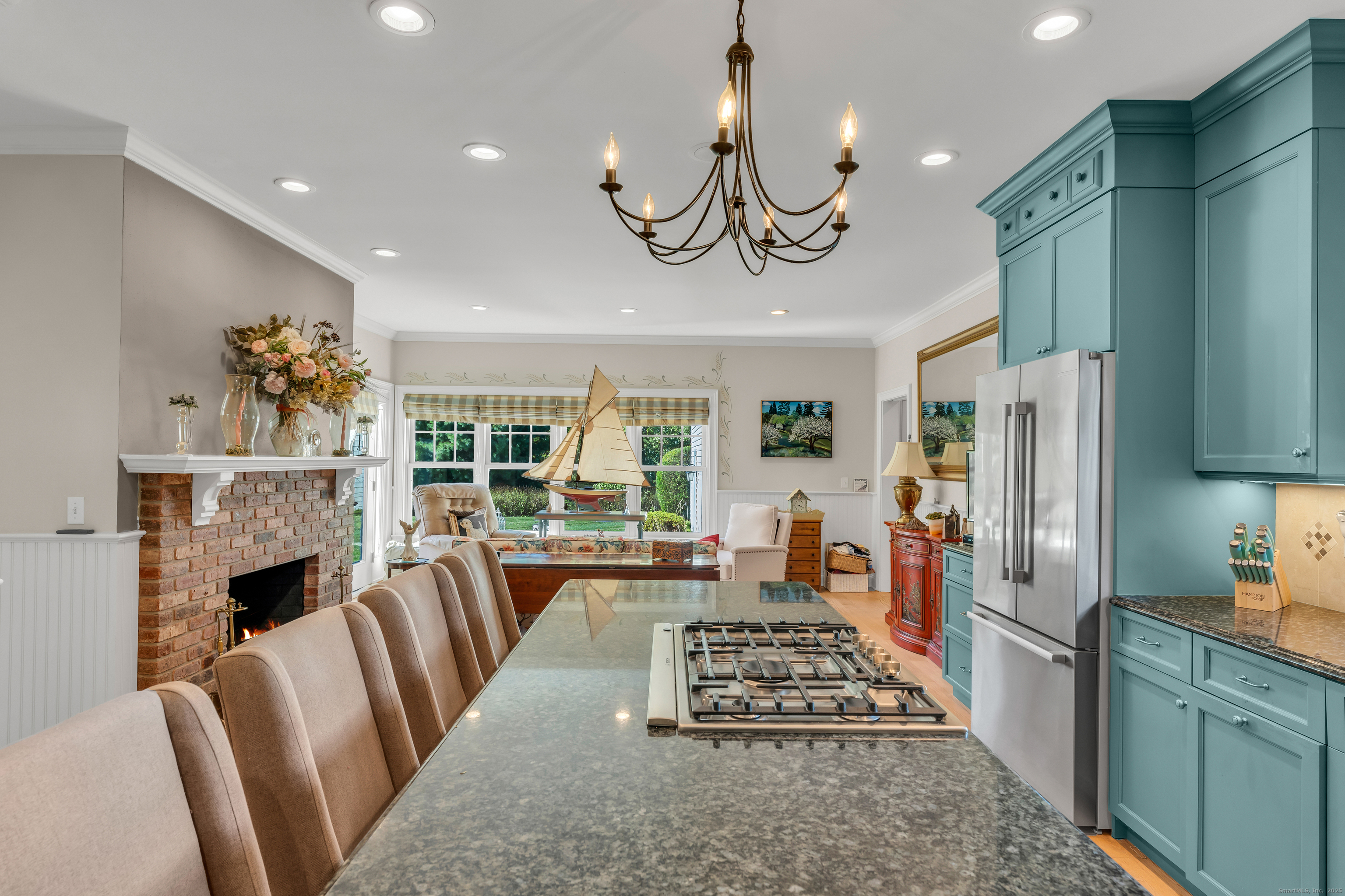 41 Allison Drive Madison, CT 06443 - Photo 14 of 40 a kitchen with stainless steel appliances granite countertop a refrigerator oven stove a sink dishwasher a dining table and chairs with wooden floor