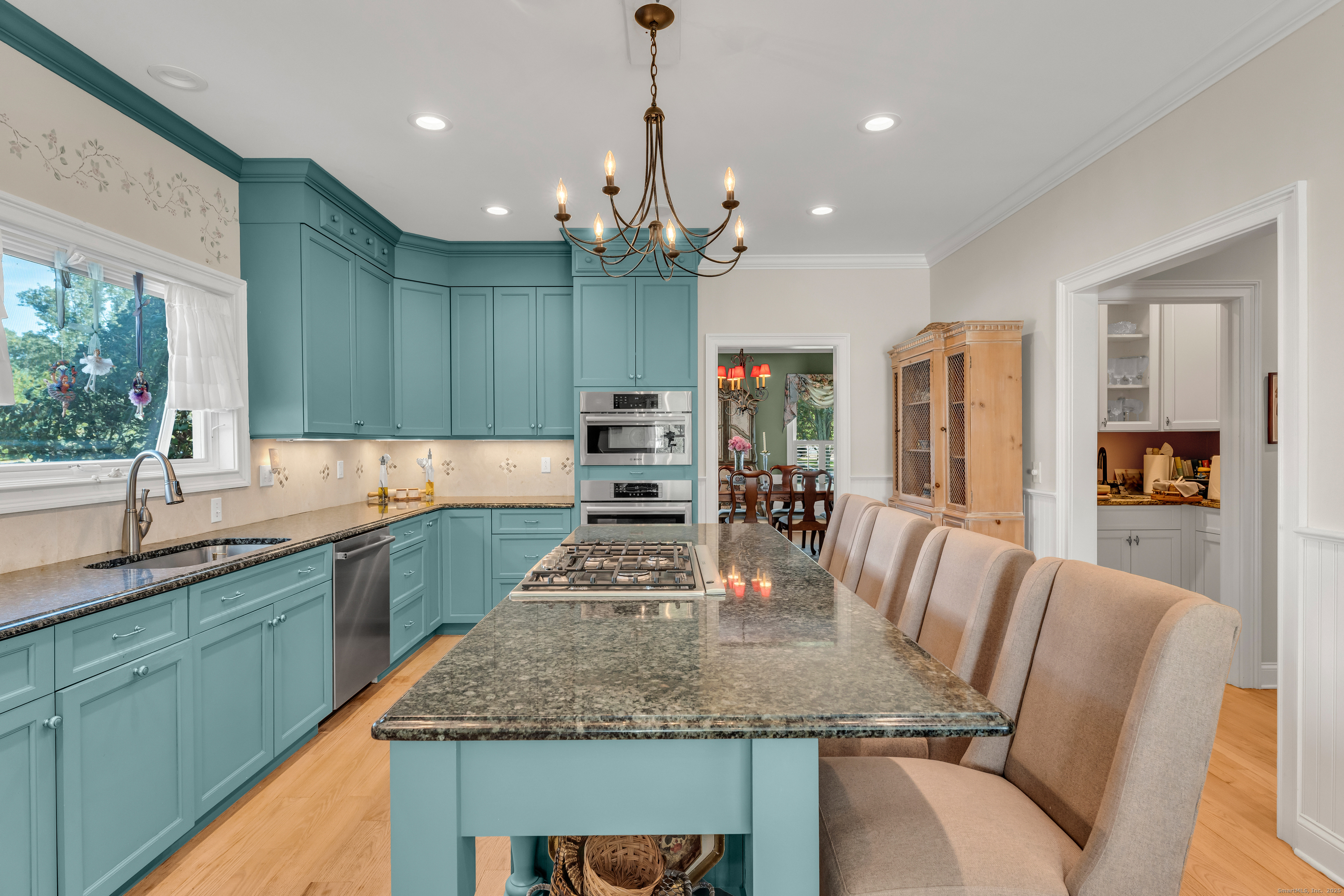 41 Allison Drive Madison, CT 06443 - Photo 16 of 40 a kitchen with center island table and chairs in it