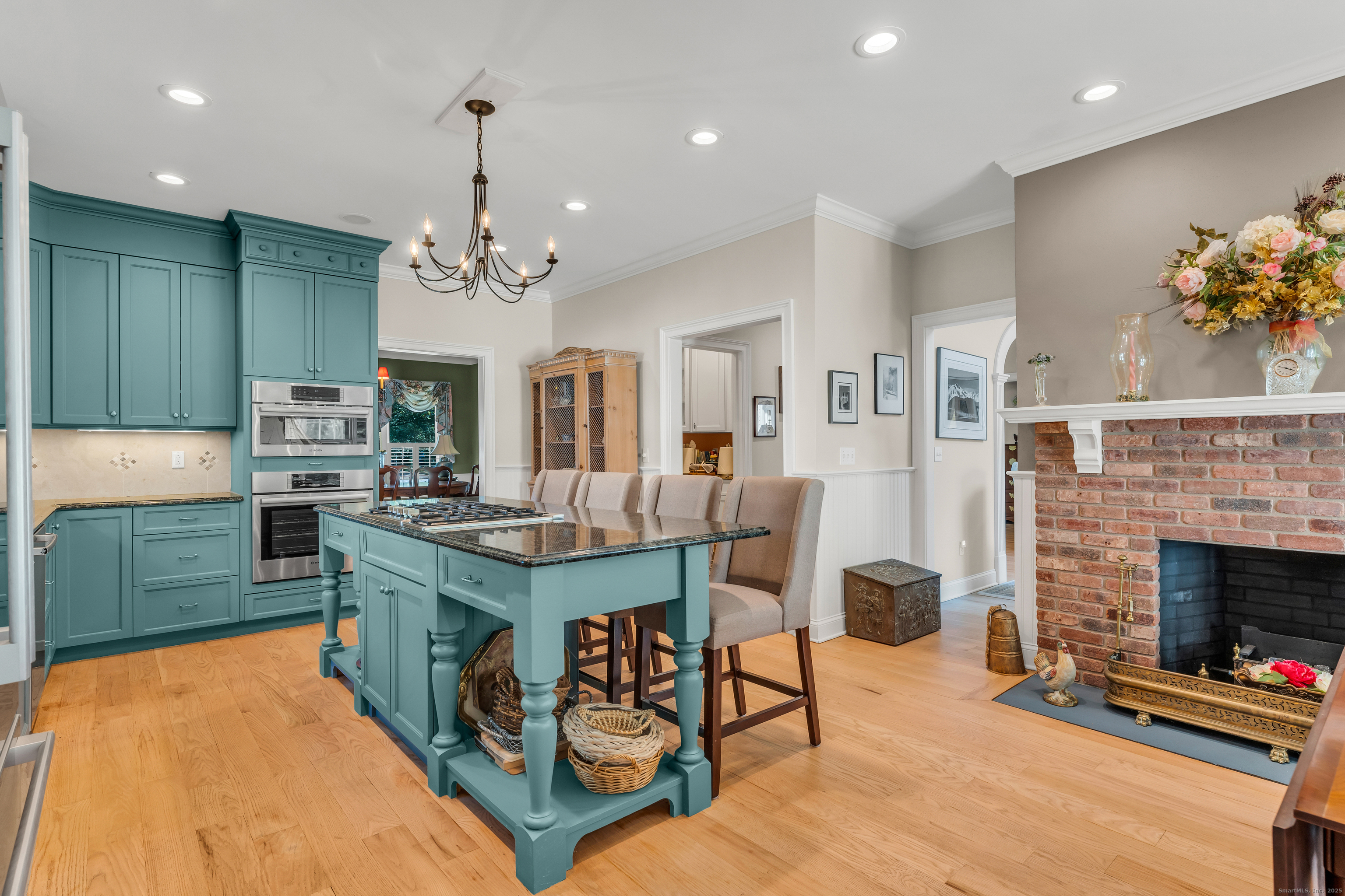 41 Allison Drive Madison, CT 06443 - Photo 17 of 40 a kitchen with stainless steel appliances granite countertop a stove top oven a sink dishwasher a dining table and chairs with wooden floor