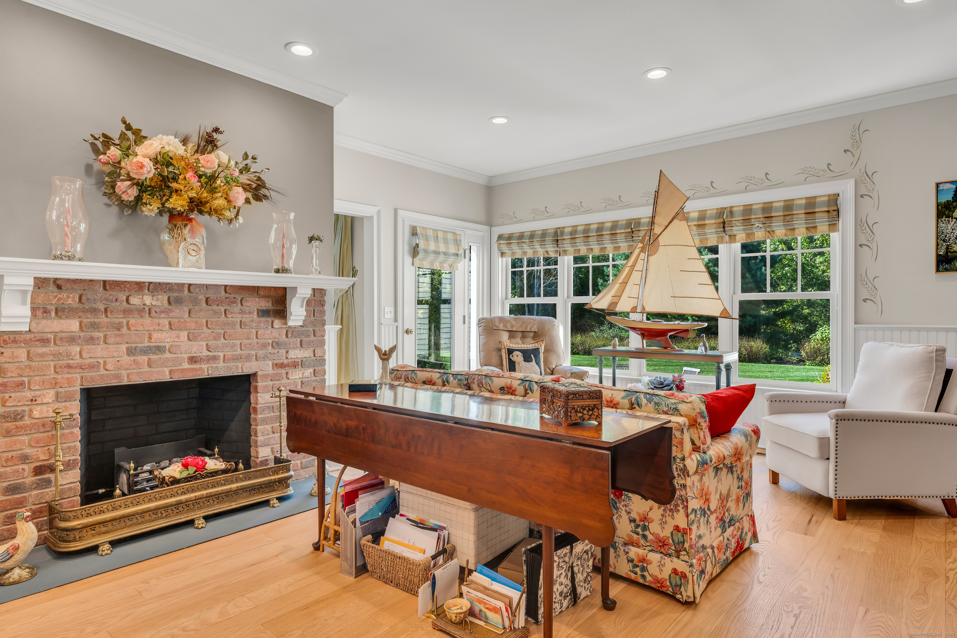 41 Allison Drive Madison, CT 06443 - Photo 19 of 40 a living room with furniture a fireplace and a floor to ceiling window