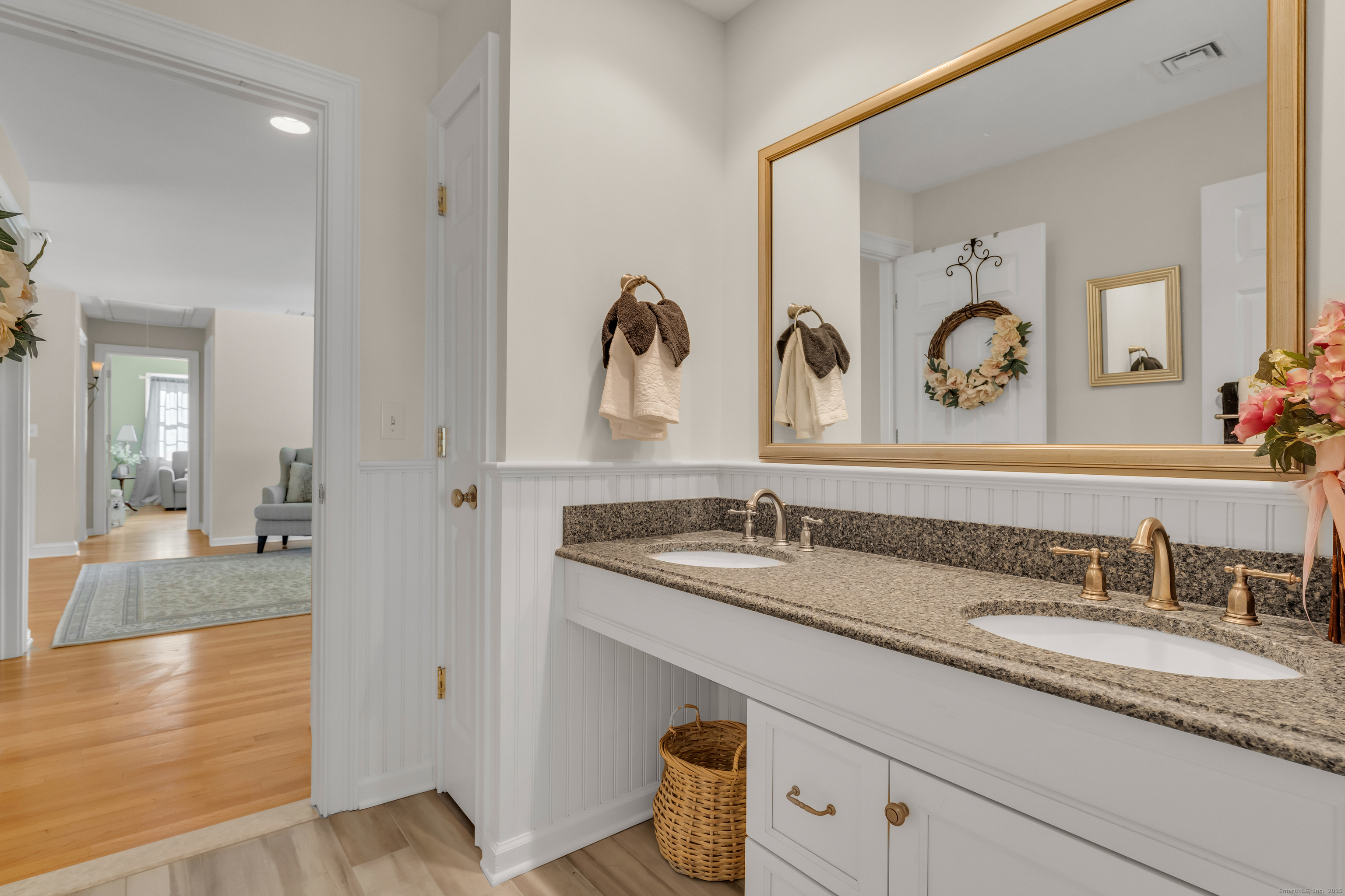 41 Allison Drive Madison, CT 06443 - Photo 32 of 40 a bathroom with a granite countertop sink and a mirror