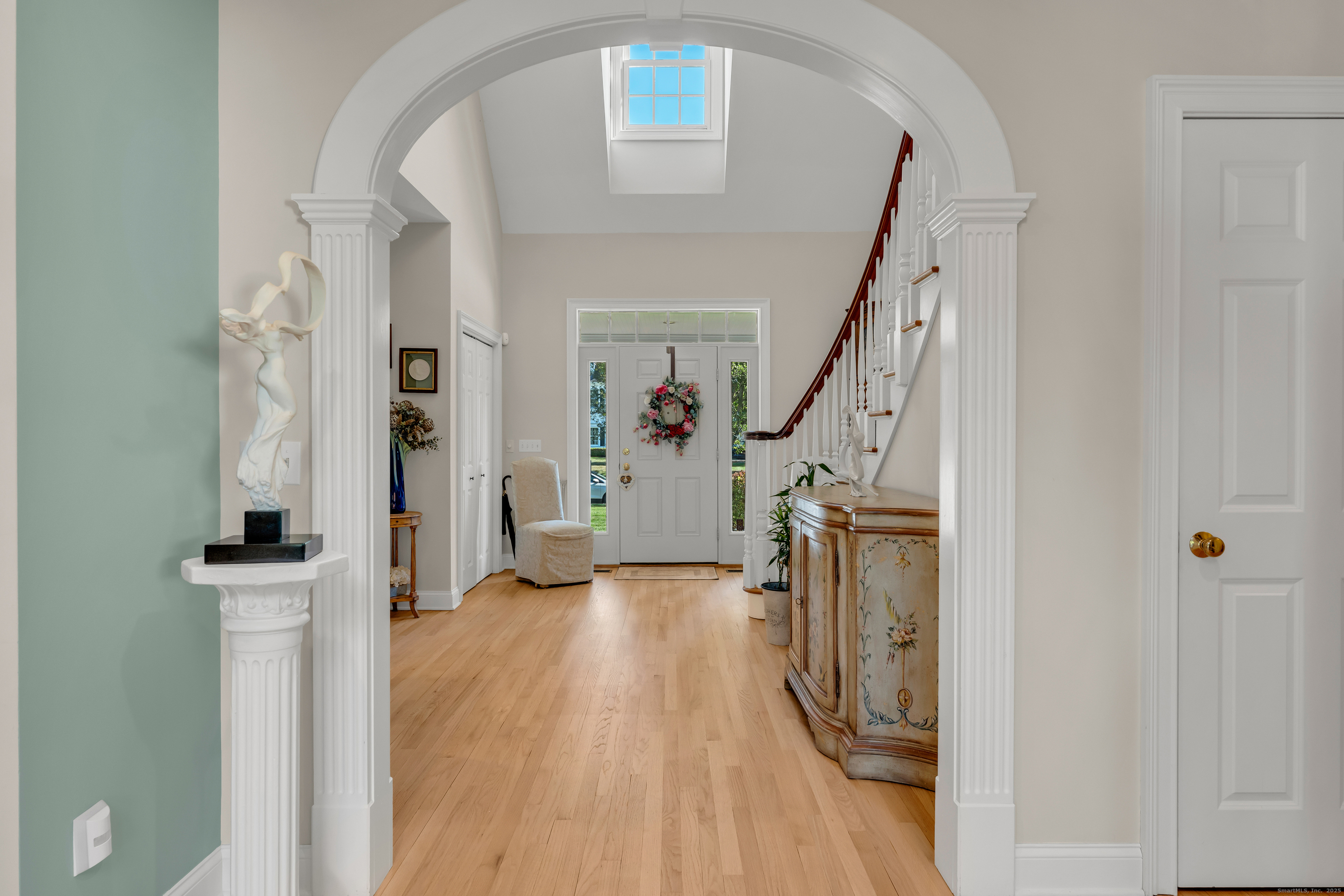 41 Allison Drive Madison, CT 06443 - Photo 10 of 40 a view of a hallway with wooden floor and staircase
