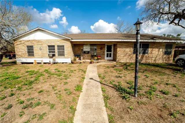 a view of a house with pool and sitting area