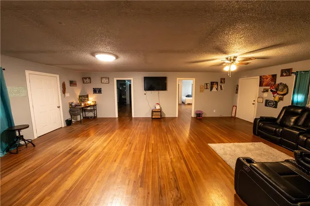 a view of a kitchen with fridge and wooden floor