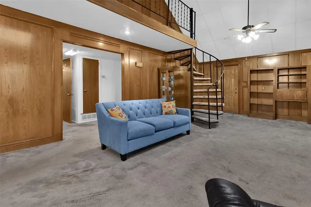 a living room with furniture and a ceiling fan