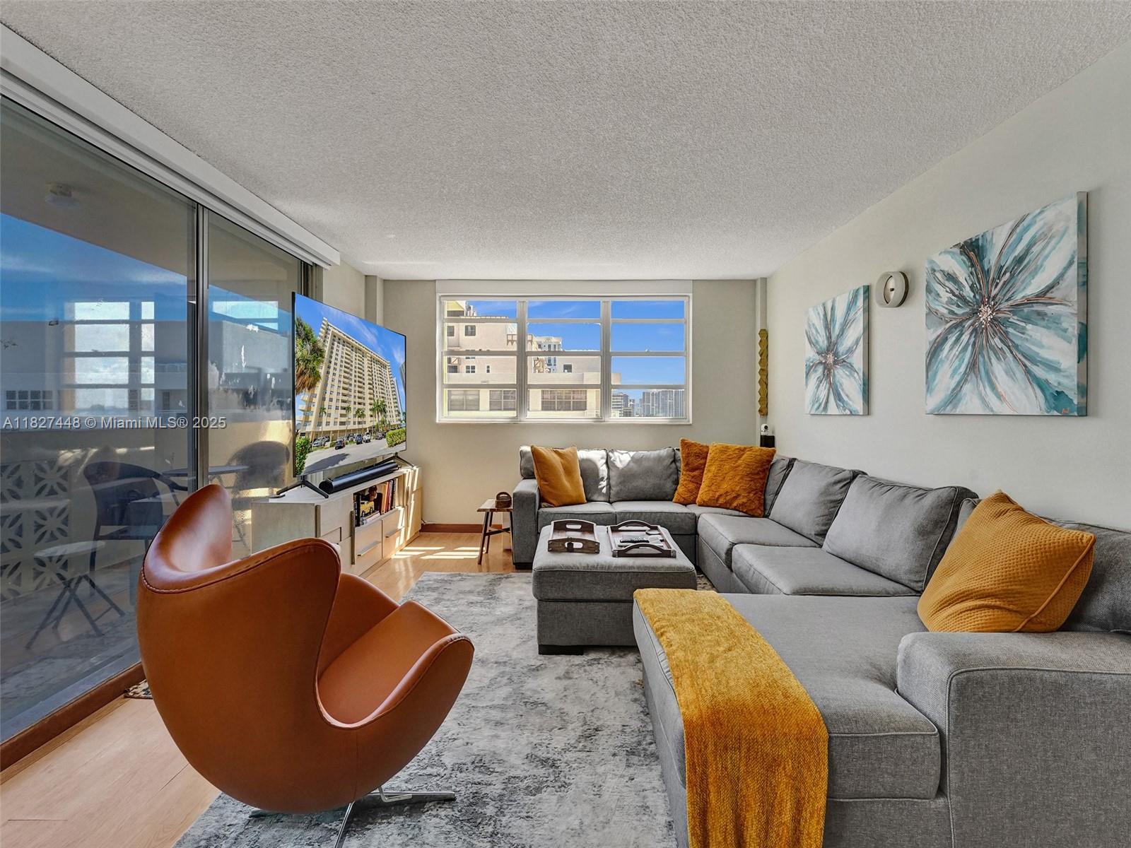 1833 South Ocean Drive, Unit 1702 Hallandale Beach, FL 33009 - Photo 11 of 80 a living room with furniture and a large window