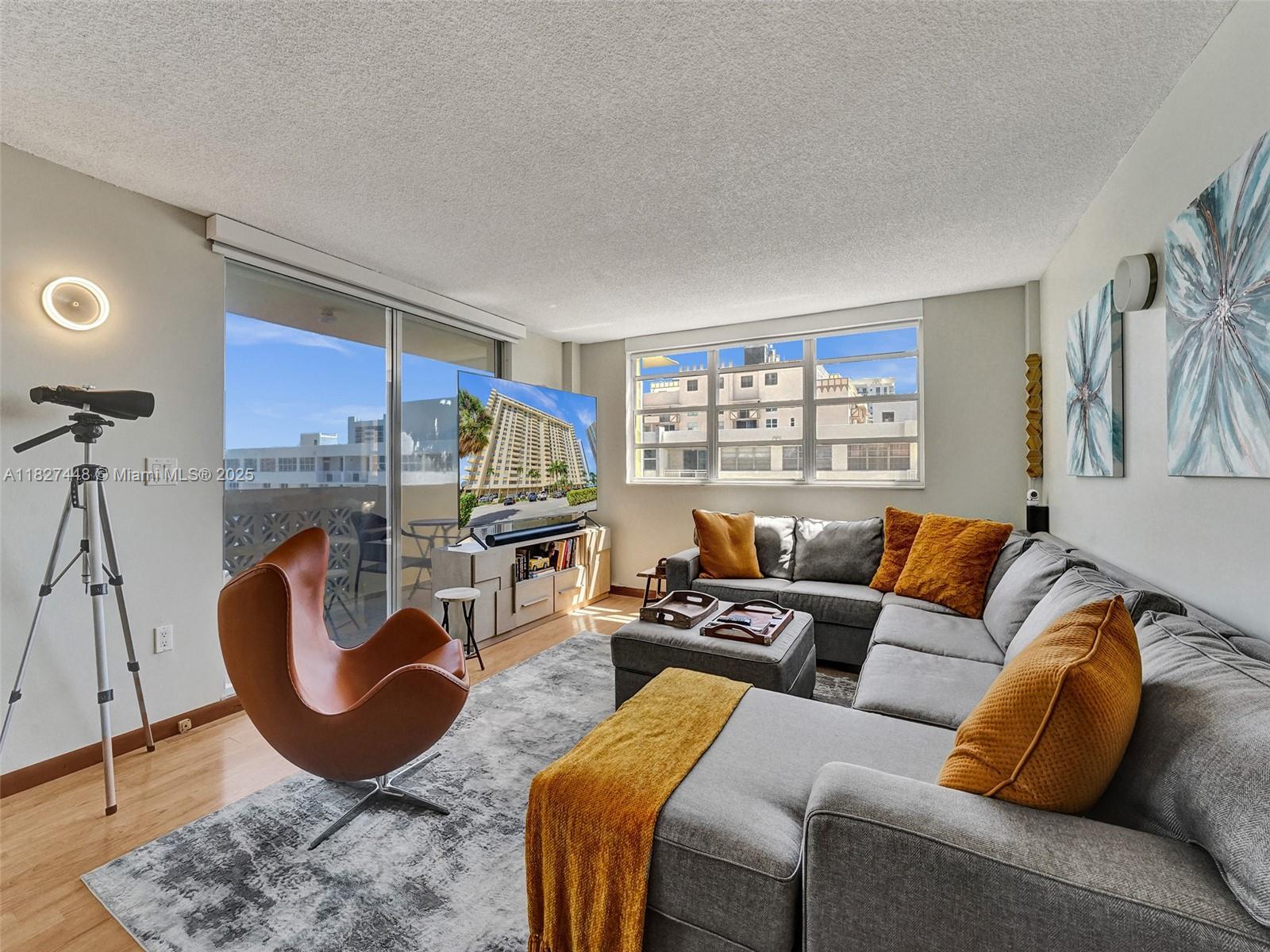 1833 South Ocean Drive, Unit 1702 Hallandale Beach, FL 33009 - Photo 12 of 80 a living room with furniture a lamp and a large window
