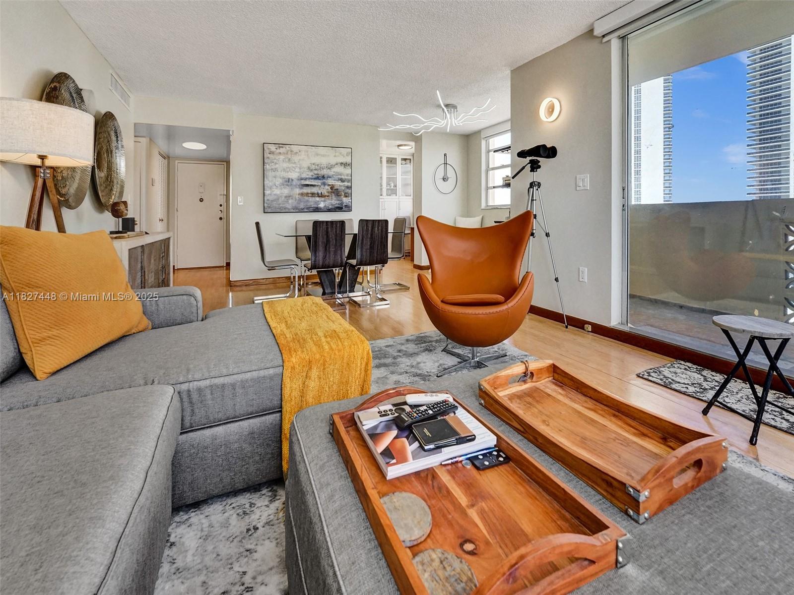 1833 South Ocean Drive, Unit 1702 Hallandale Beach, FL 33009 - Photo 15 of 80 a living room with furniture rug and window
