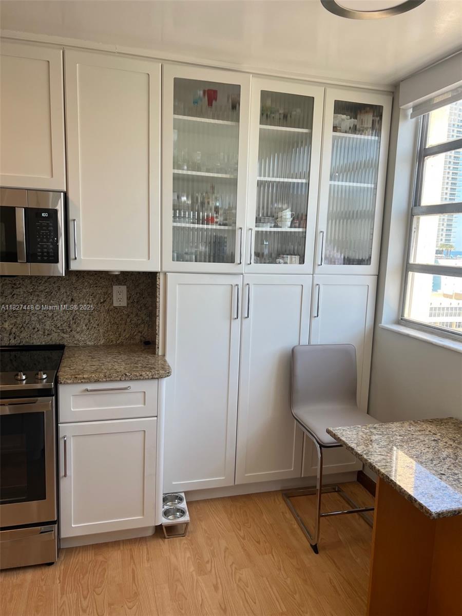 1833 South Ocean Drive, Unit 1702 Hallandale Beach, FL 33009 - Photo 20 of 80 a living room with furniture and a fireplace