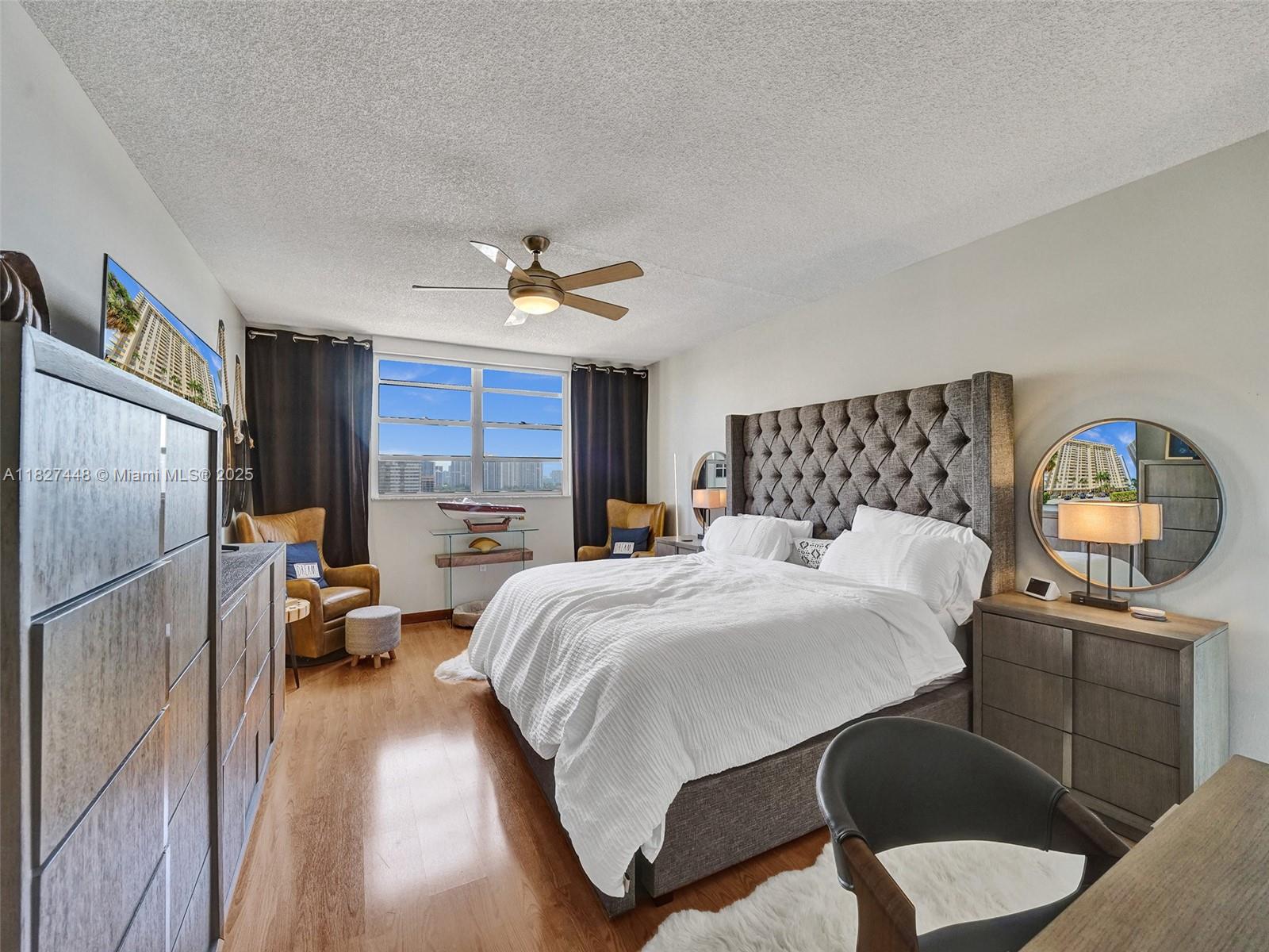 1833 South Ocean Drive, Unit 1702 Hallandale Beach, FL 33009 - Photo 29 of 80 a bedroom with a bed and wooden floor