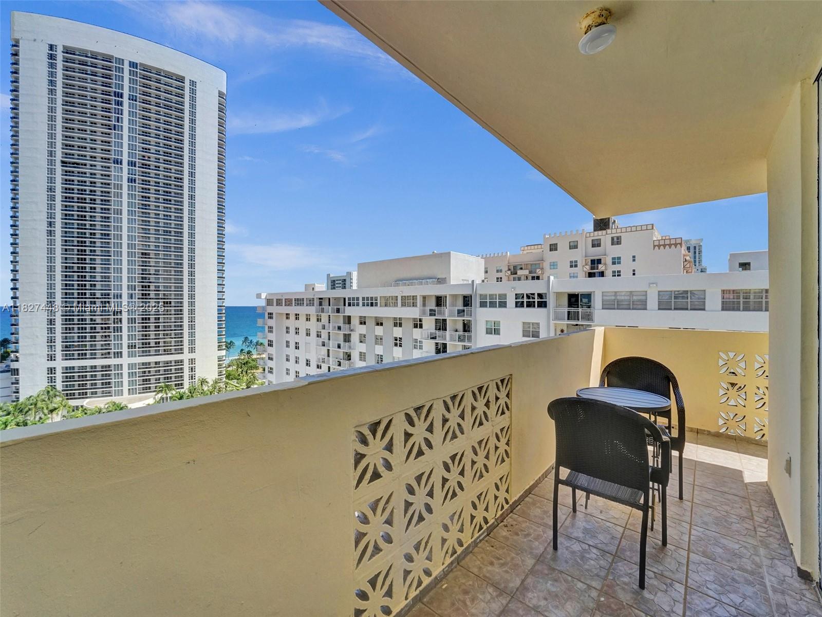 1833 South Ocean Drive, Unit 1702 Hallandale Beach, FL 33009 - Photo 43 of 80 a balcony with table and chairs