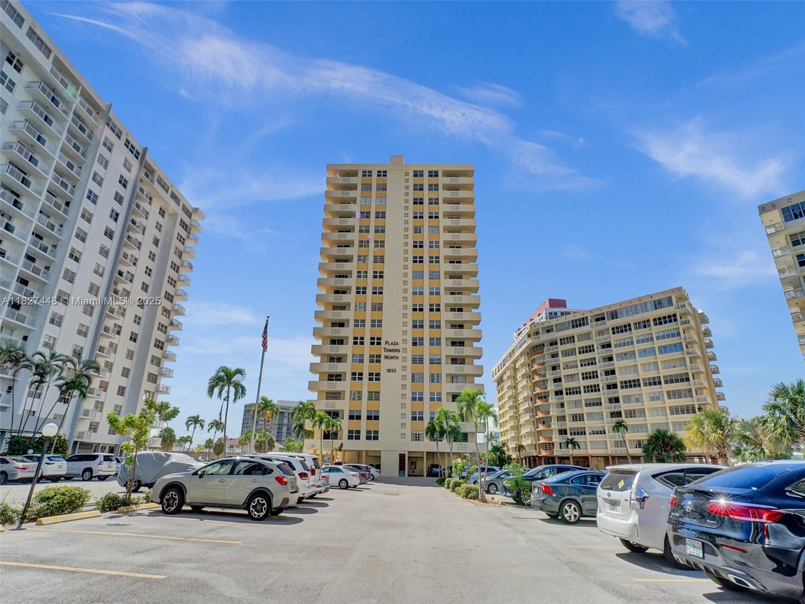 1833 South Ocean Drive, Unit 1702 Hallandale Beach, FL 33009 - Photo 66 of 80 a city street lined with parked cars and buildings