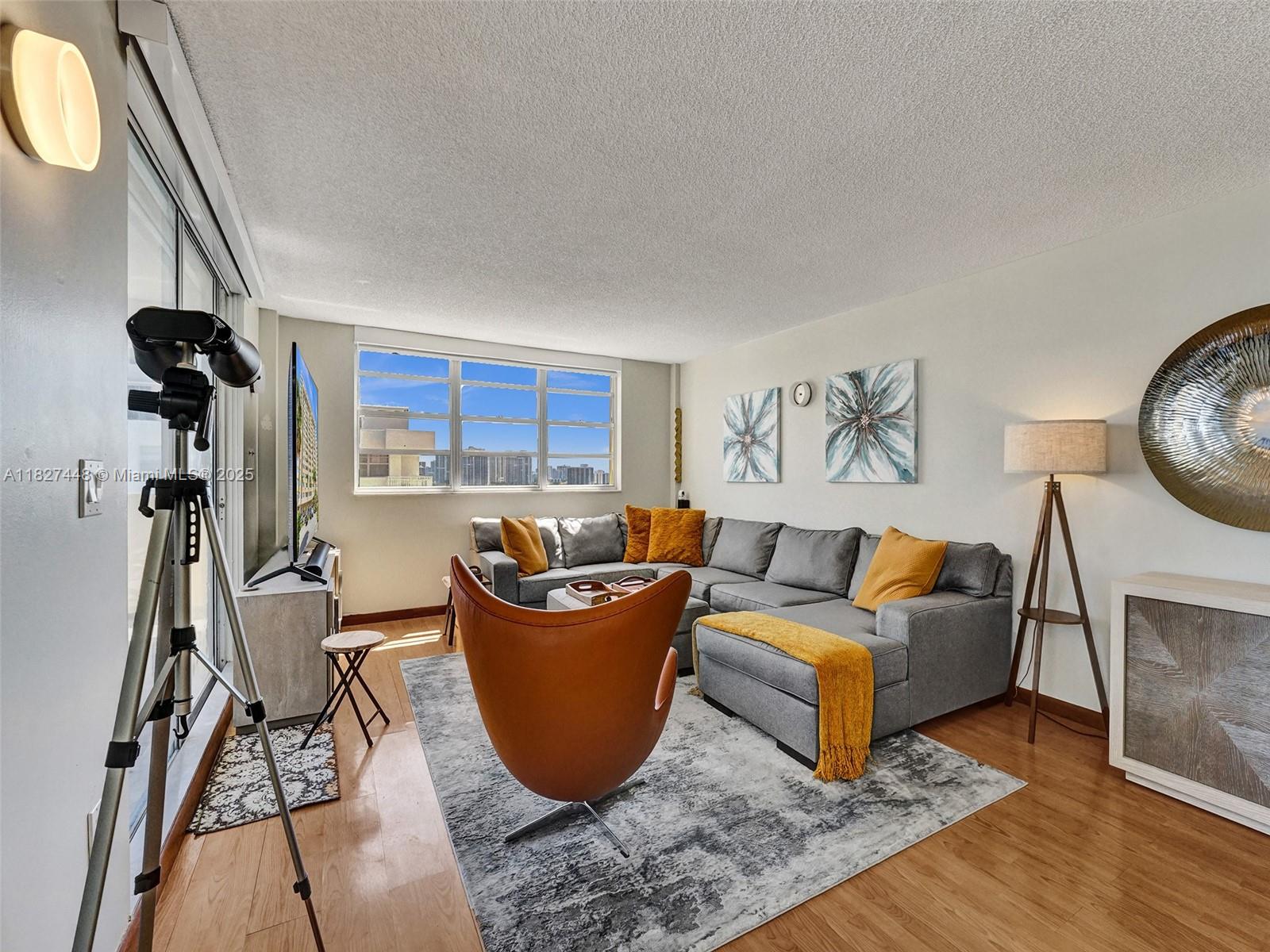 1833 South Ocean Drive, Unit 1702 Hallandale Beach, FL 33009 - Photo 10 of 80 a living room with furniture and a wooden floor