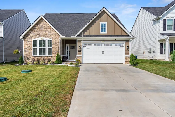 a front view of a house with a yard