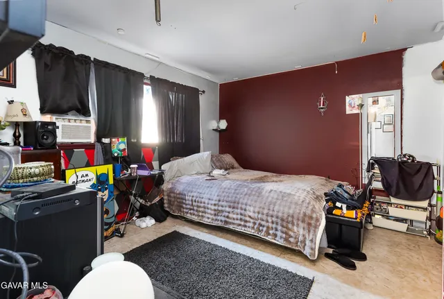 a bedroom with a bed a couch and dresser