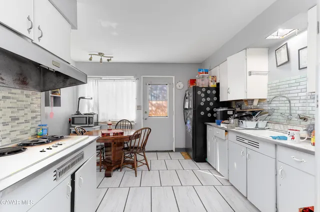 a kitchen with stainless steel appliances kitchen island granite countertop a sink and cabinets