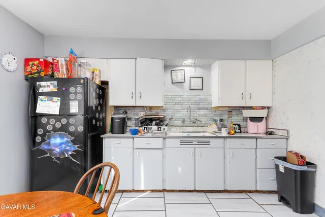 a kitchen with stainless steel appliances a refrigerator sink and cabinets