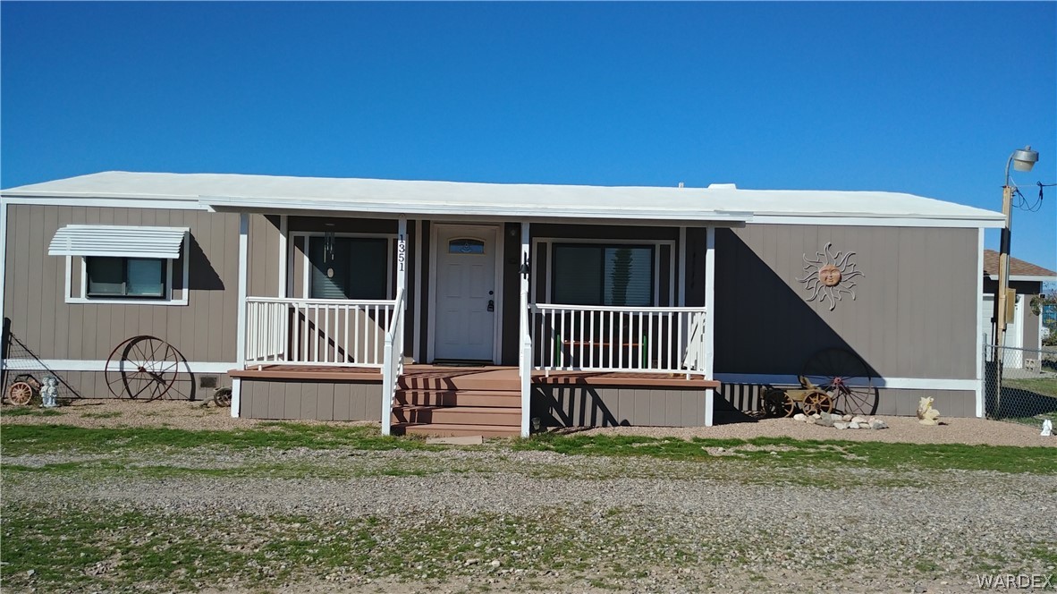 4057 Cavalry Road Fort Mohave, AZ 86426 - Photo 1 of 12 a front view of a house with garden