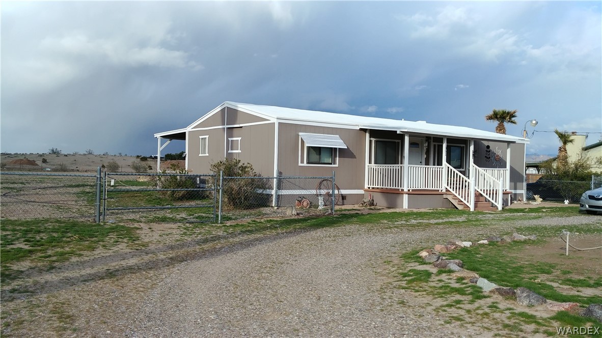 4057 Cavalry Road Fort Mohave, AZ 86426 - Photo 2 of 12 a view of a house with a yard