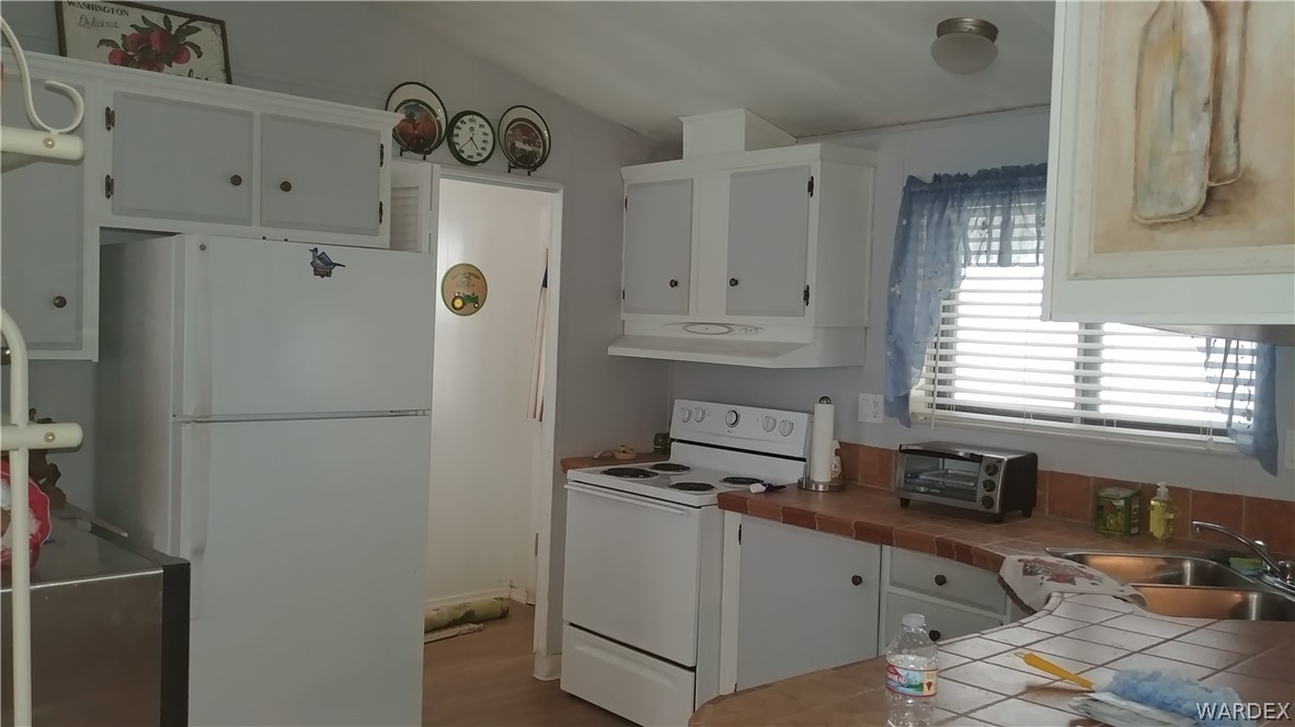 4057 Cavalry Road Fort Mohave, AZ 86426 - Photo 6 of 12 a kitchen with cabinets and window