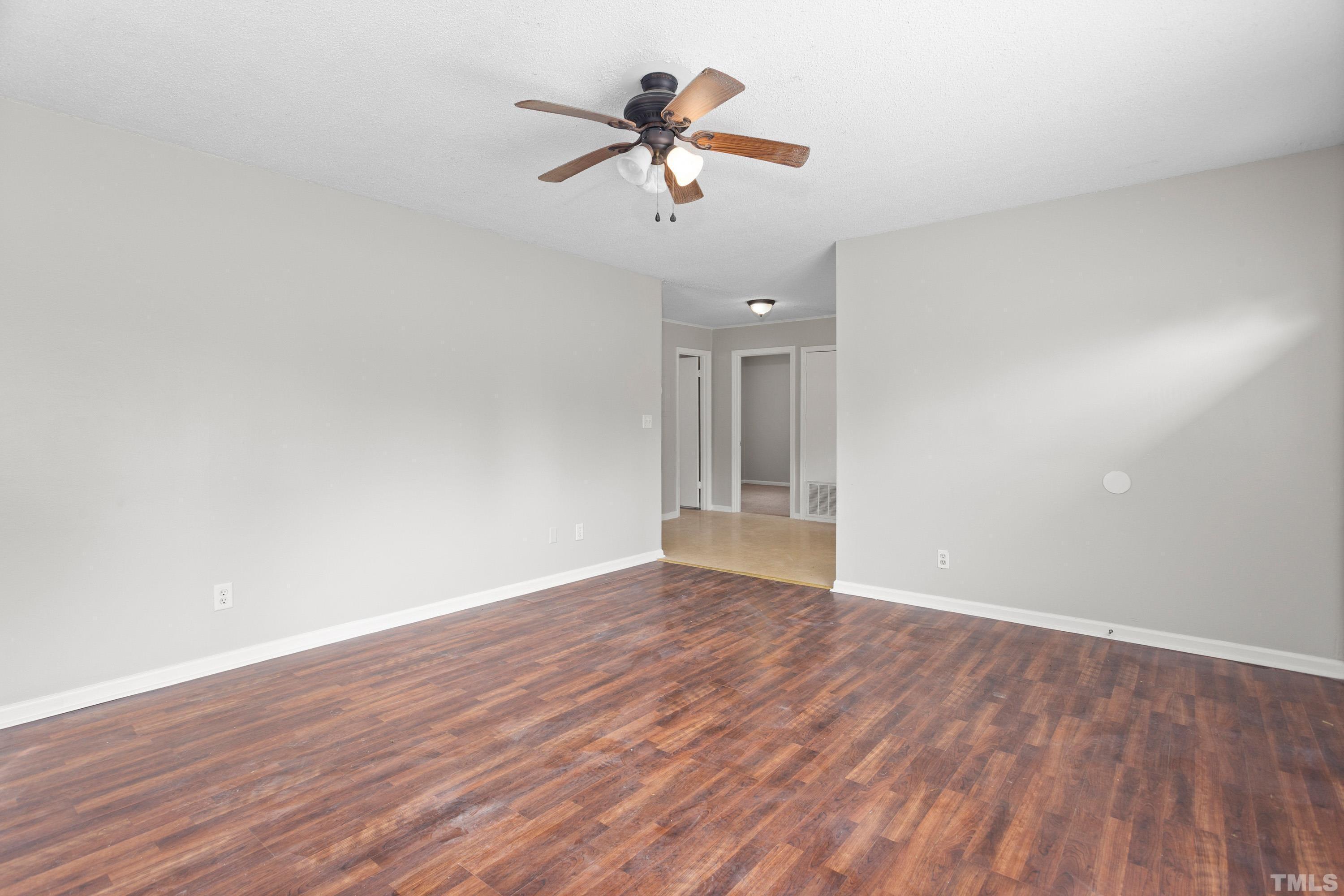 143 Spring Park Road Wake Forest, NC 27587 - Photo 7 of 29 a view of room with wooden floor and ceiling fan
