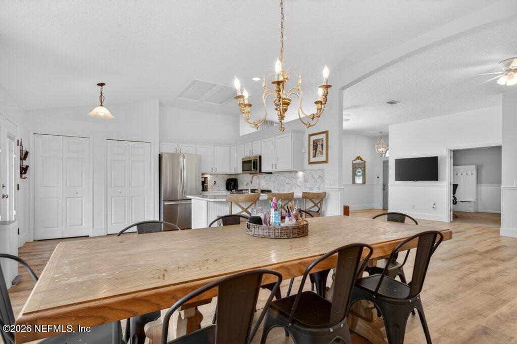 1441 Tintern Lane St. Augustine, FL 32092 - Photo 18 of 57 a kitchen with kitchen island a dining table and chairs