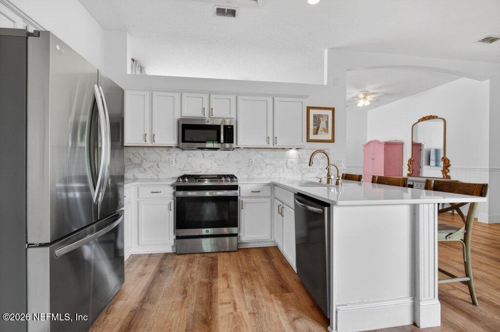 1441 Tintern Lane St. Augustine, FL 32092 - Photo 23 of 57 a kitchen with stainless steel appliances a stove refrigerator sink and microwave