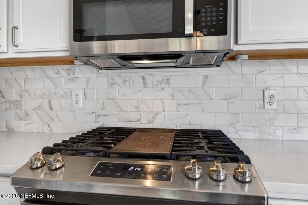 1441 Tintern Lane St. Augustine, FL 32092 - Photo 24 of 57 a stove top oven sitting inside of a kitchen