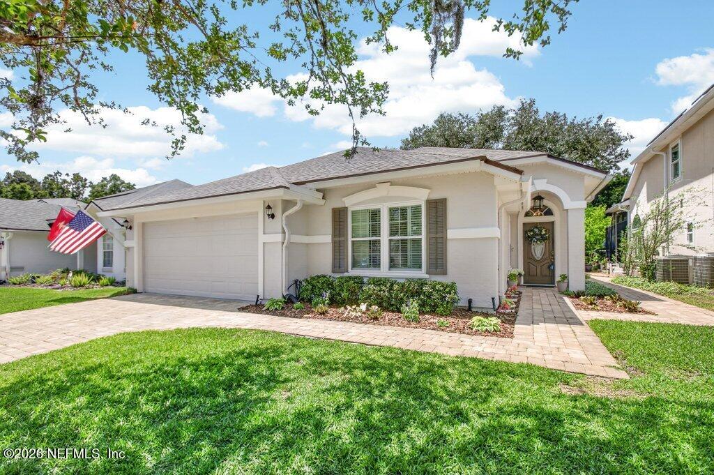 1441 Tintern Lane St. Augustine, FL 32092 - Photo 4 of 57 a front view of a house with a yard and potted plants