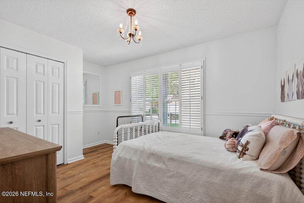 1441 Tintern Lane St. Augustine, FL 32092 - Photo 43 of 57 a bedroom with a bed and a table in it