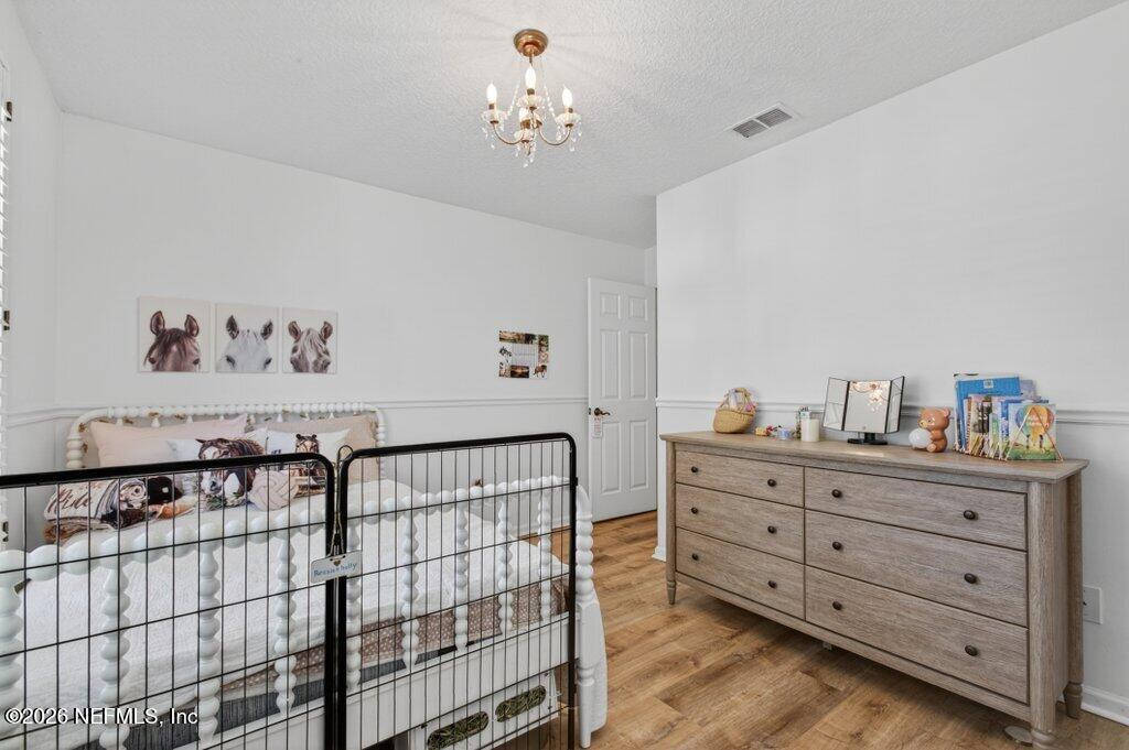 1441 Tintern Lane St. Augustine, FL 32092 - Photo 44 of 57 a bedroom with a baby bed baby crib and a dresser