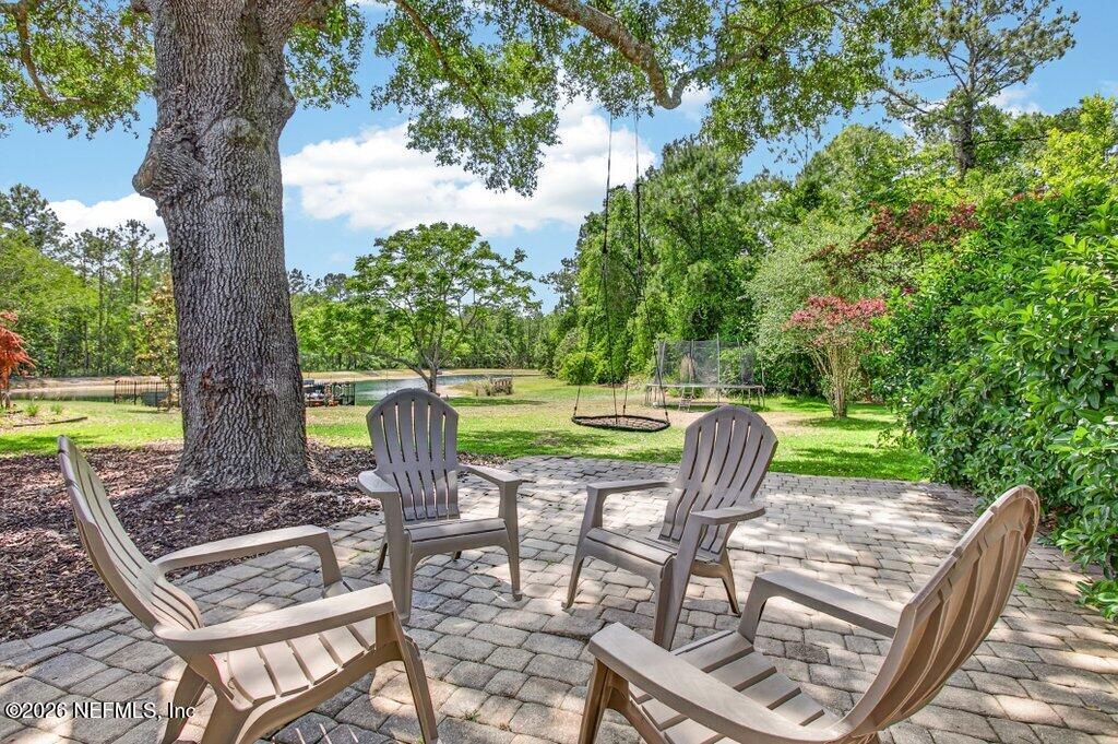 1441 Tintern Lane St. Augustine, FL 32092 - Photo 49 of 57 a view of a chairs and table in backyard
