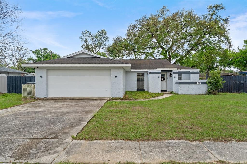 128 Euclid Avenue Seffner, FL 33584 - Photo 1 of 38 a front view of a house with a yard and garage