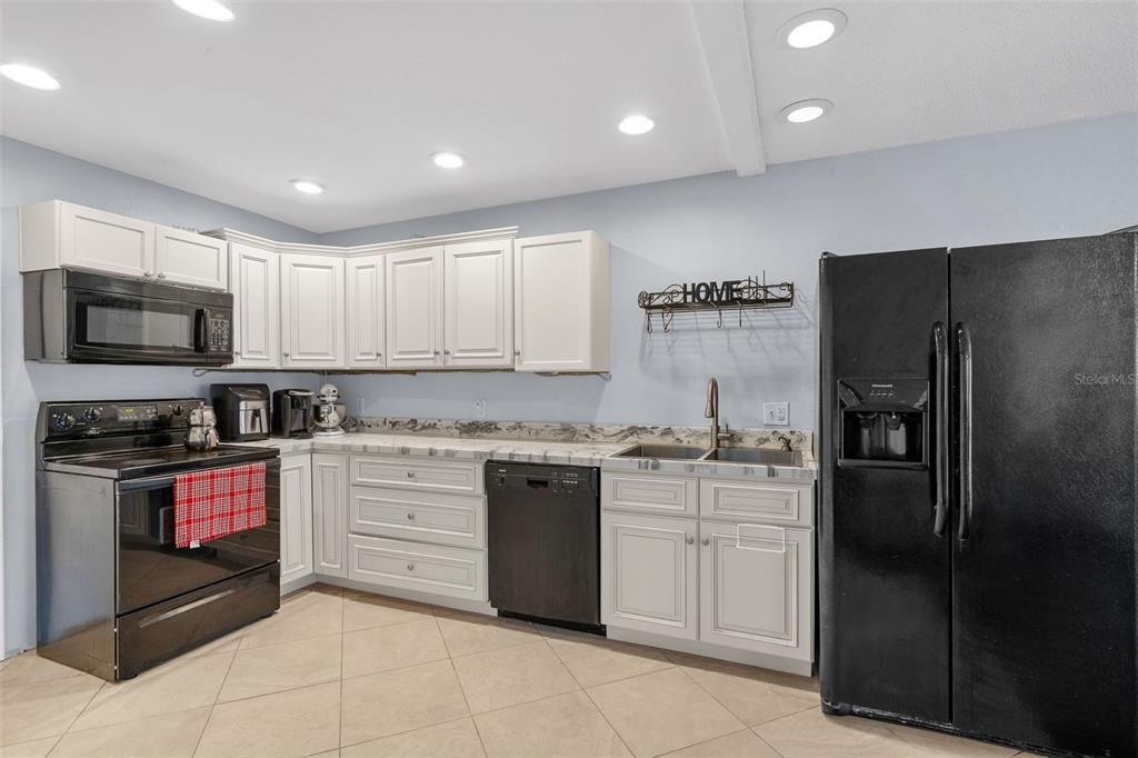 128 Euclid Avenue Seffner, FL 33584 - Photo 12 of 38 a kitchen with stainless steel appliances granite countertop a refrigerator and a stove top oven